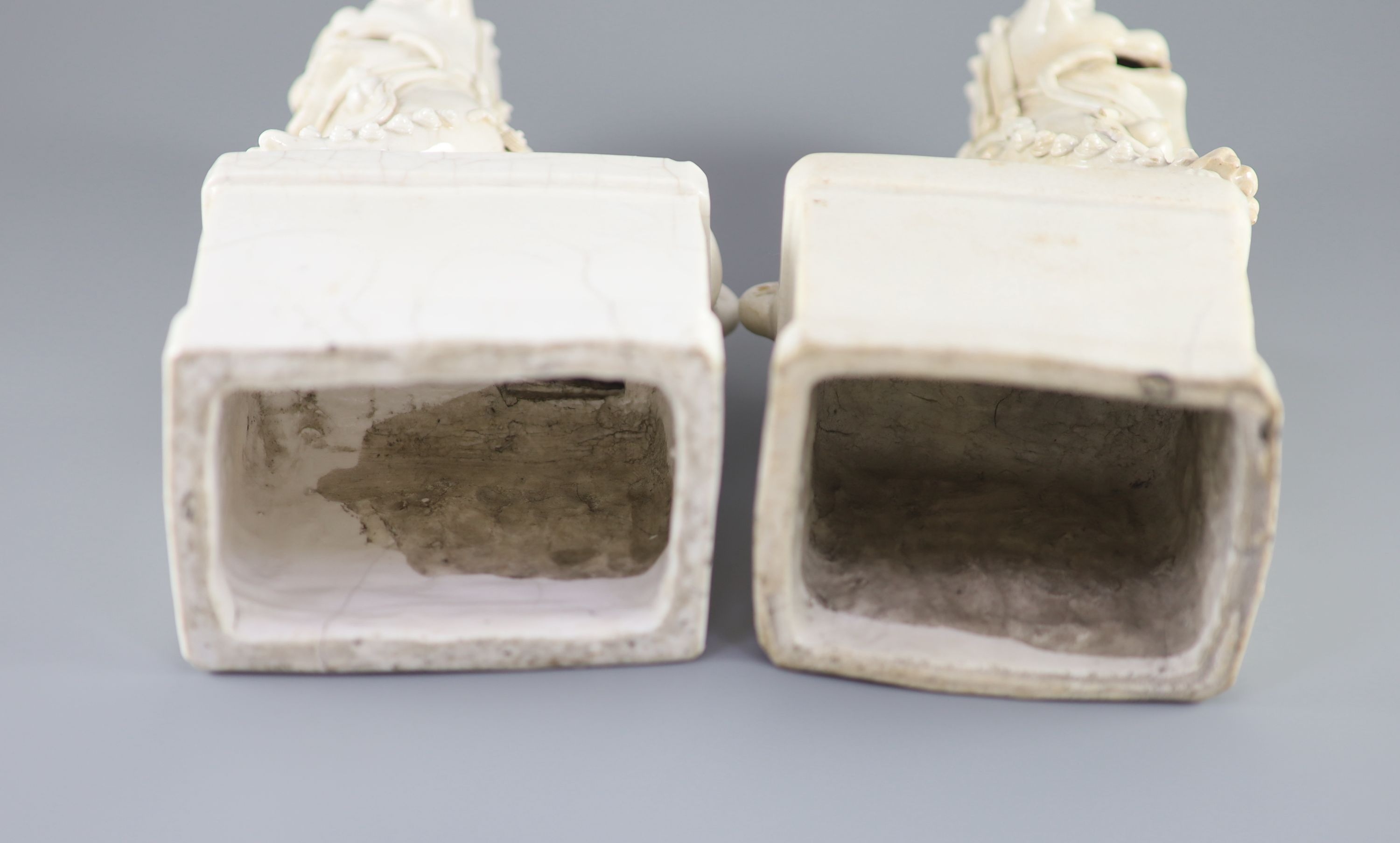 A pair of Chinese Dehua Blanc de chine kylin joss stick holders, some cracks. 26cms
